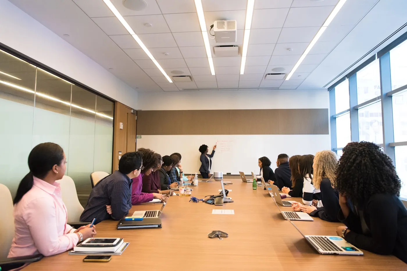 Responsable de formación explicando el plan de idiomas a su equipo en una sala de reuniones